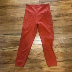 Orange Girlfriend Collective leggings with pockets